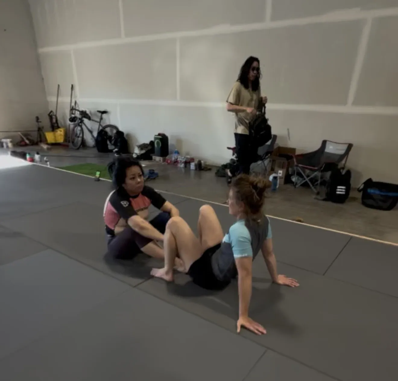 Athletes chatting and resetting between rounds at the academy.