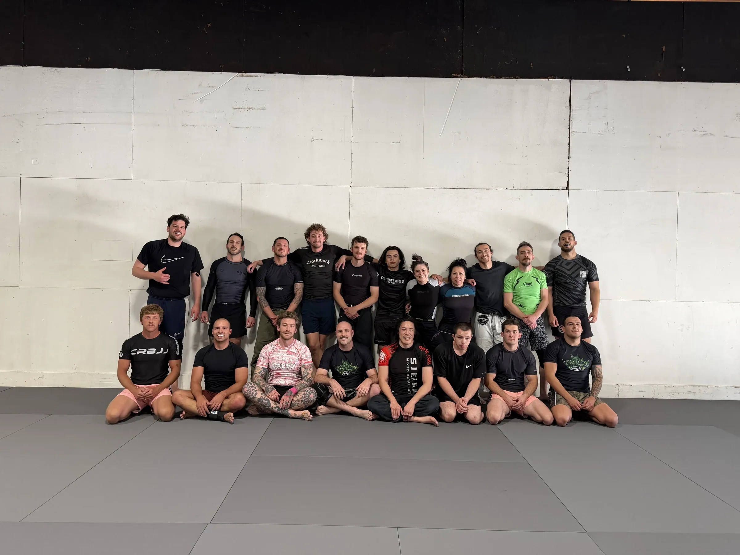 Large class lined up together on the mats after training.