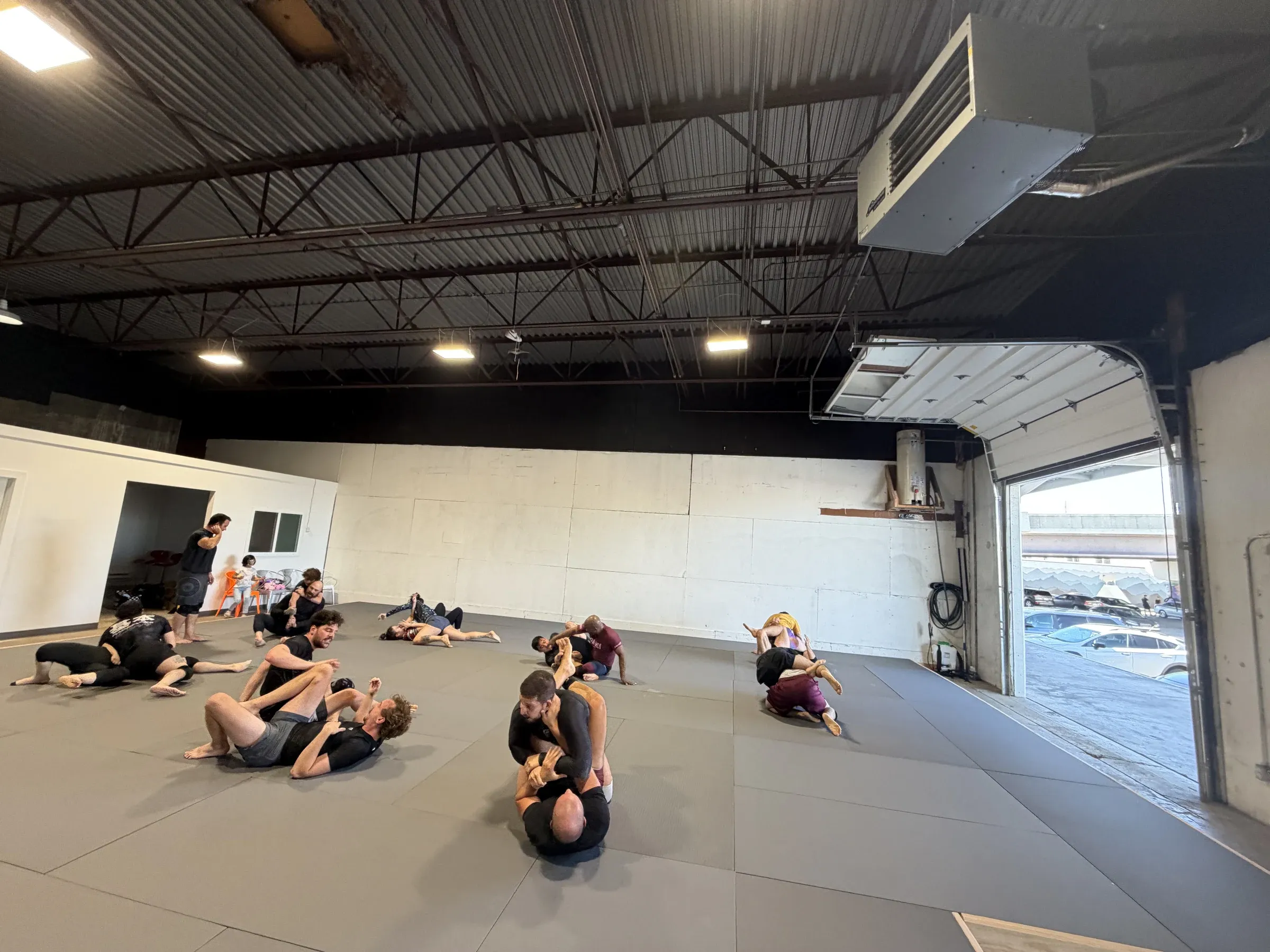 Students rolling during class at Neighborhood Jiu Jitsu