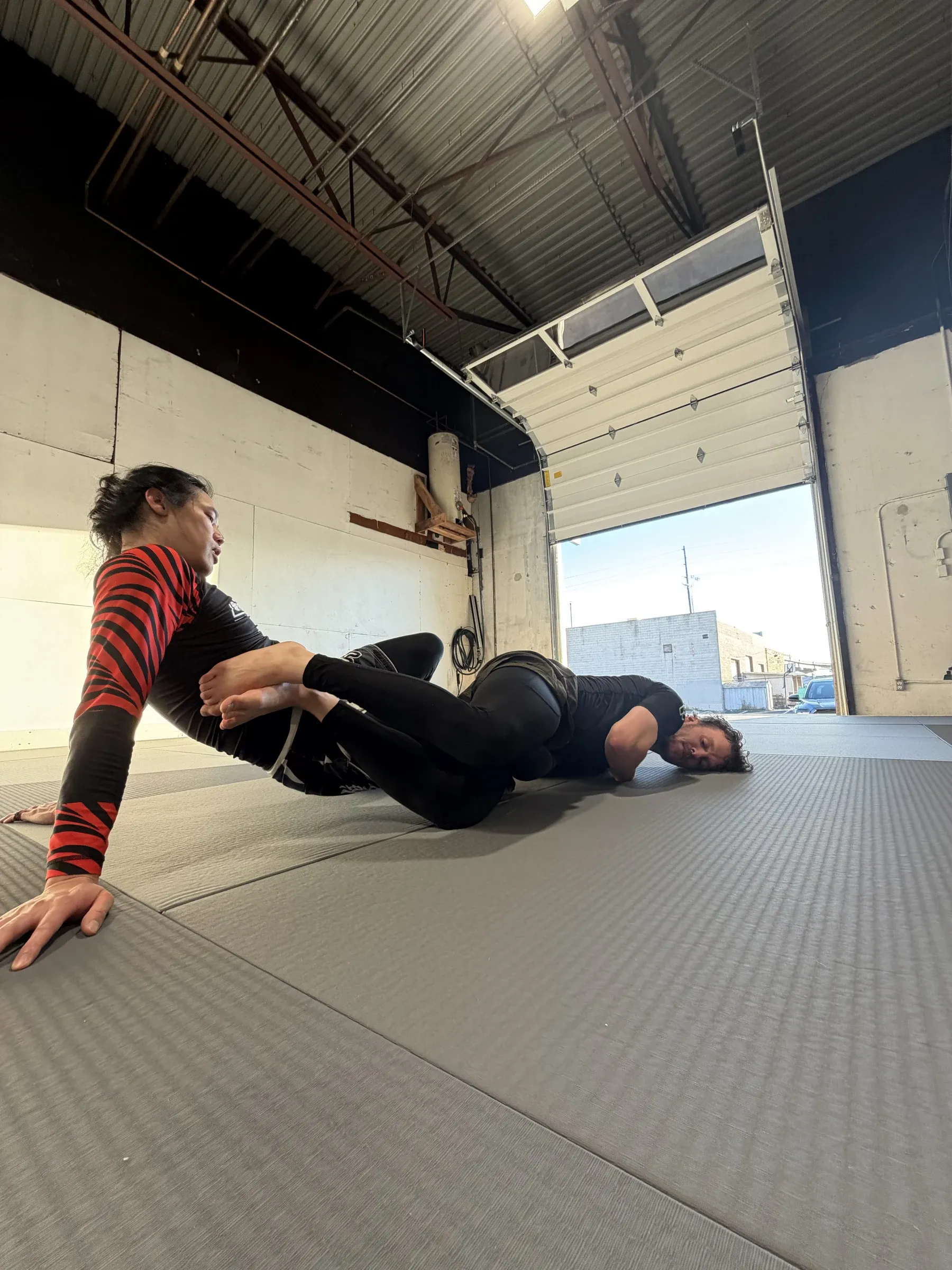 Two students working through a leg entanglement during training