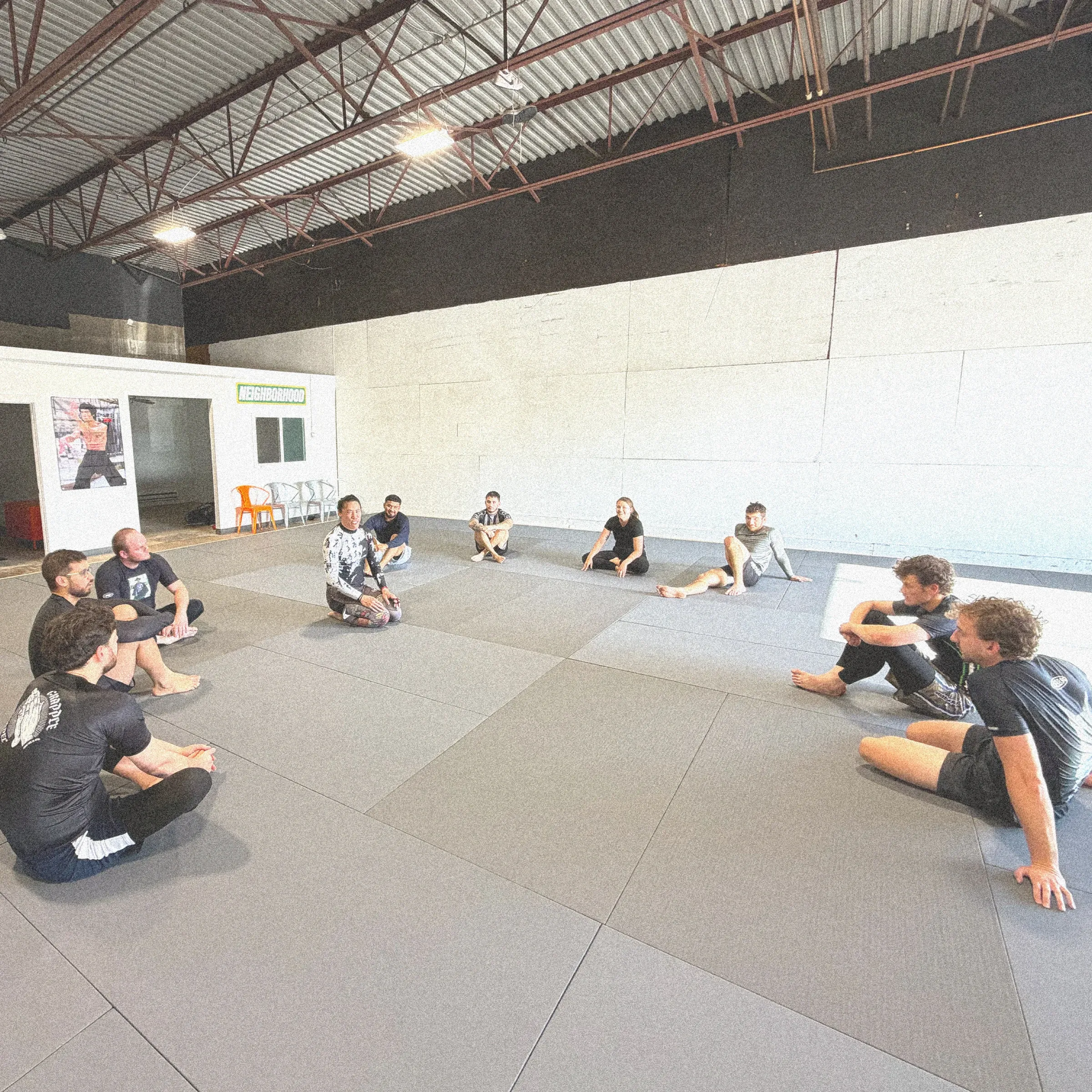 Coach leading students through technique details during class.