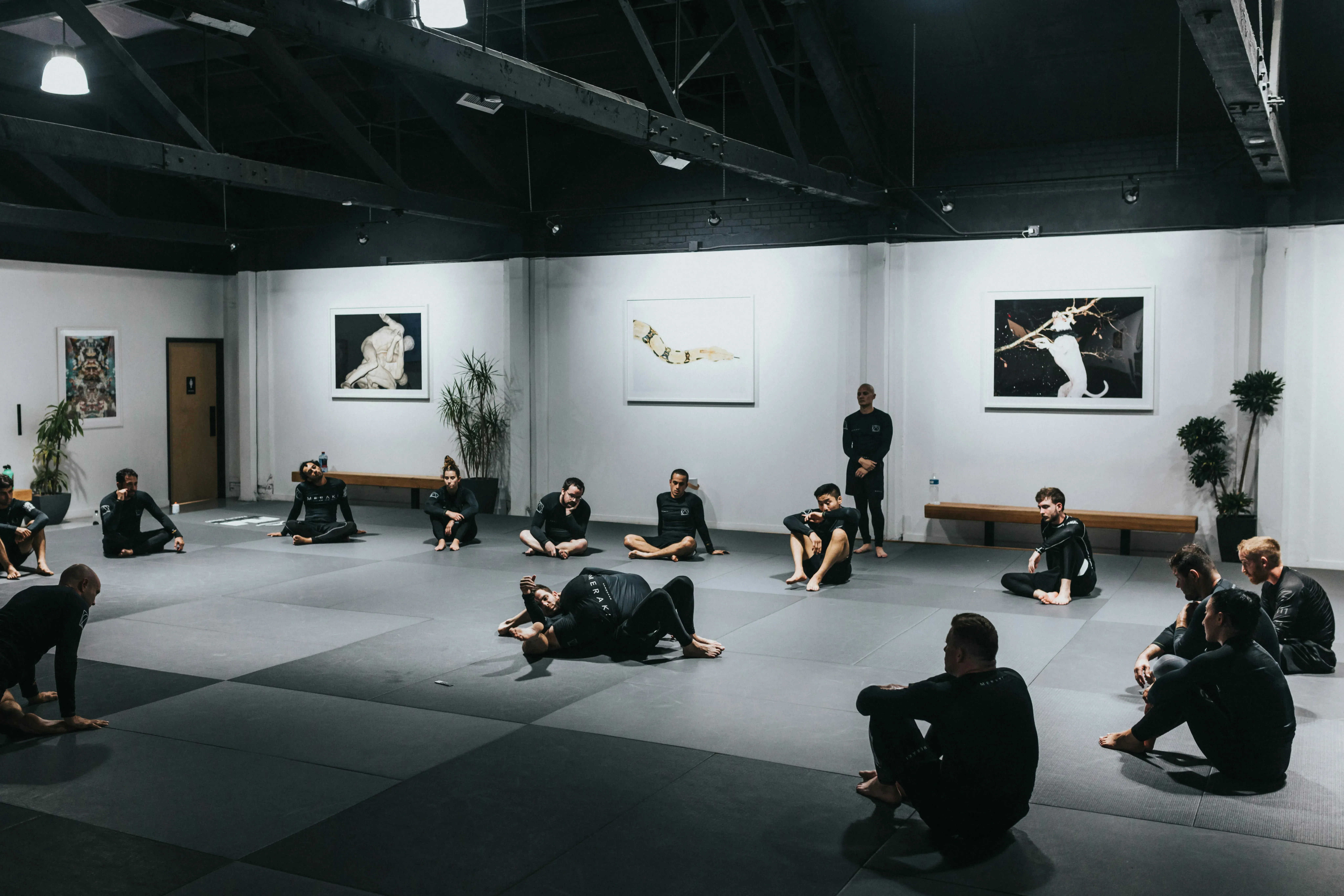 Gritty Jiu Jitsu training session in dark warehouse
